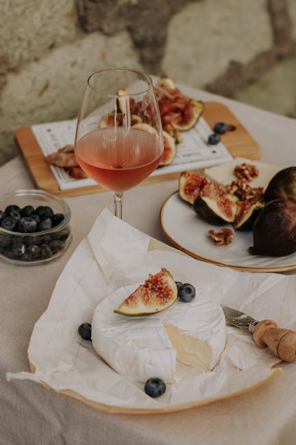 pexels photo 12991635 12991635 1 A rustic setup of brie cheese, figs, and rose wine, perfect for a gourmet snack.